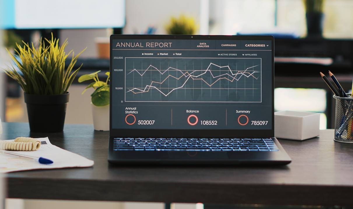 business-graphs-figures-laptop-left-open-desk-empty-office (1)