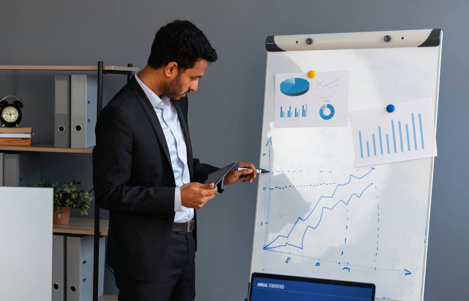 business-person-looking-finance-graphs (2) (1)